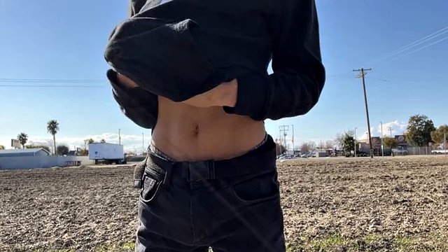 A sexy young man undresses in different parts of the city
