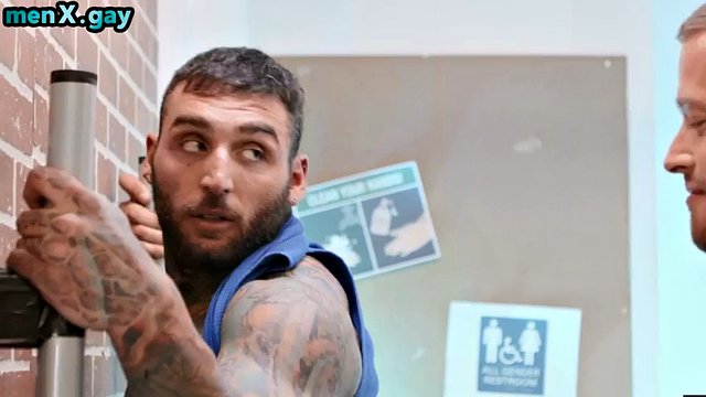 A manly athlete with a muscular and tattooed body fucks a police officer in the bathroom