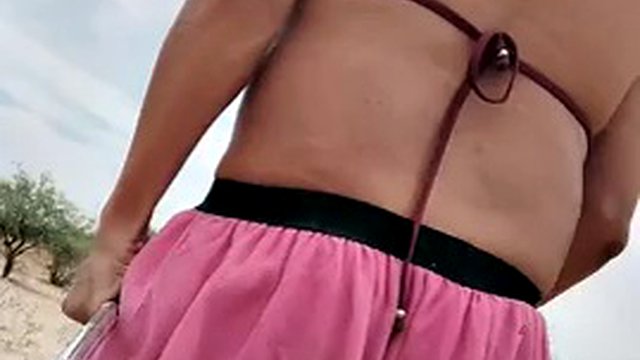Sweet hot shemale in miniskirt, bra and red heels walks sexy in public