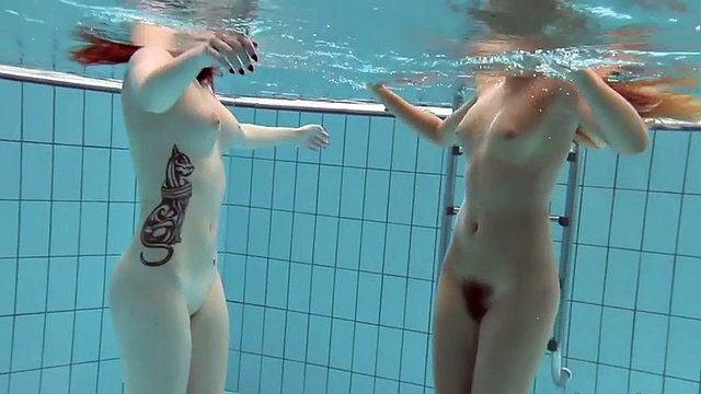 naughty katrin and lucy swim naked in a swimming pool