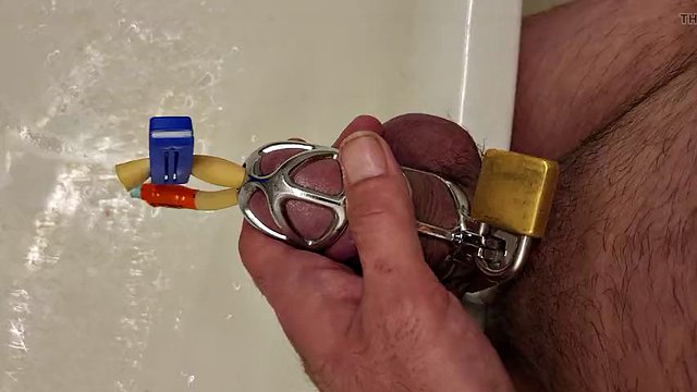 Pissing with a catheter locked in a chastity cage