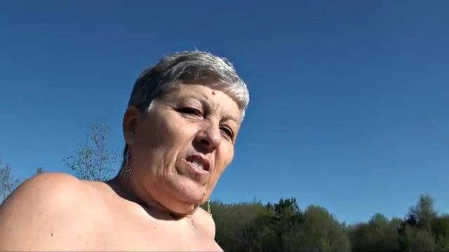 Gray-haired grandmother strips naked in the lake
