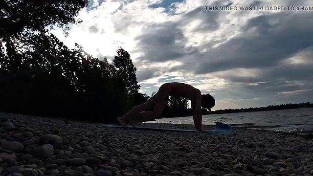 Slim nudist boy doing yoga naked on a nudist beach. Nude yoga video by John Artin, gay porn model, skinny naturist, twink, practice