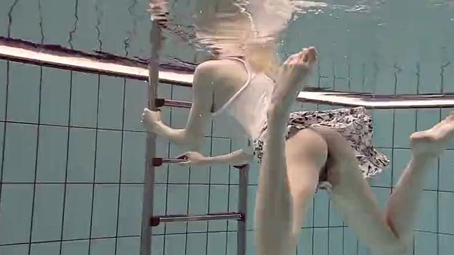 Blonde Okuneva shaved pussy swims underwater