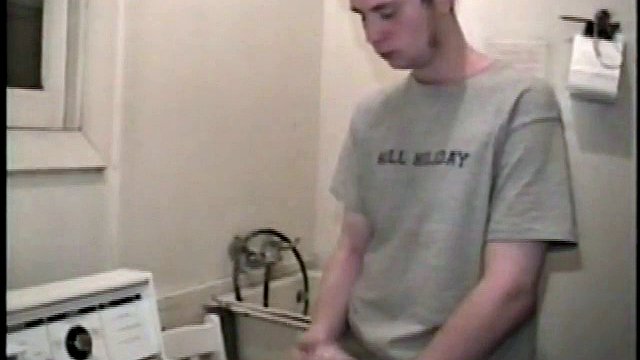 This guy from next door spreads his new porn magazine on the washing machine and pulls his cock out from under the fly of his baggy shorts without even letting his balls play.