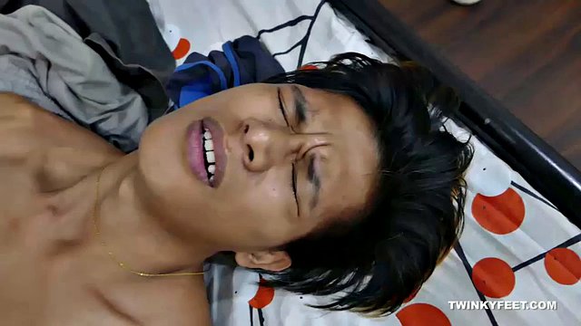 This sexy asian gay foot fetishist has beautiful slender male feet. He starts off putting his pretty boy feet down then walks over to the bed to tease you with them. He starts sucking his toes and rubbing his cock all over his smooth soles.