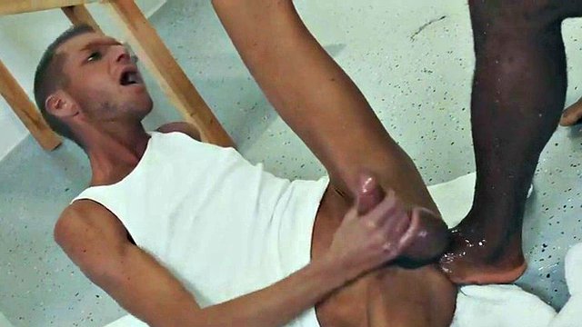 A black hunk with his fist fucks a skinny and greedy gay with his foot