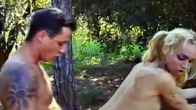 Young blonde shemale Claudia Hunter in red latex boots enjoys getting her ass pounded in the woods